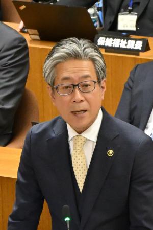 市長が市議会の中で話をしているところ